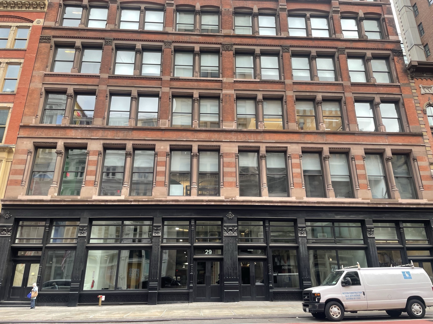 Facade of Iron23 at 29 West 23rd Street: a red brick and brownstone building with a black cast-iron storefront and the number 29 over the door.