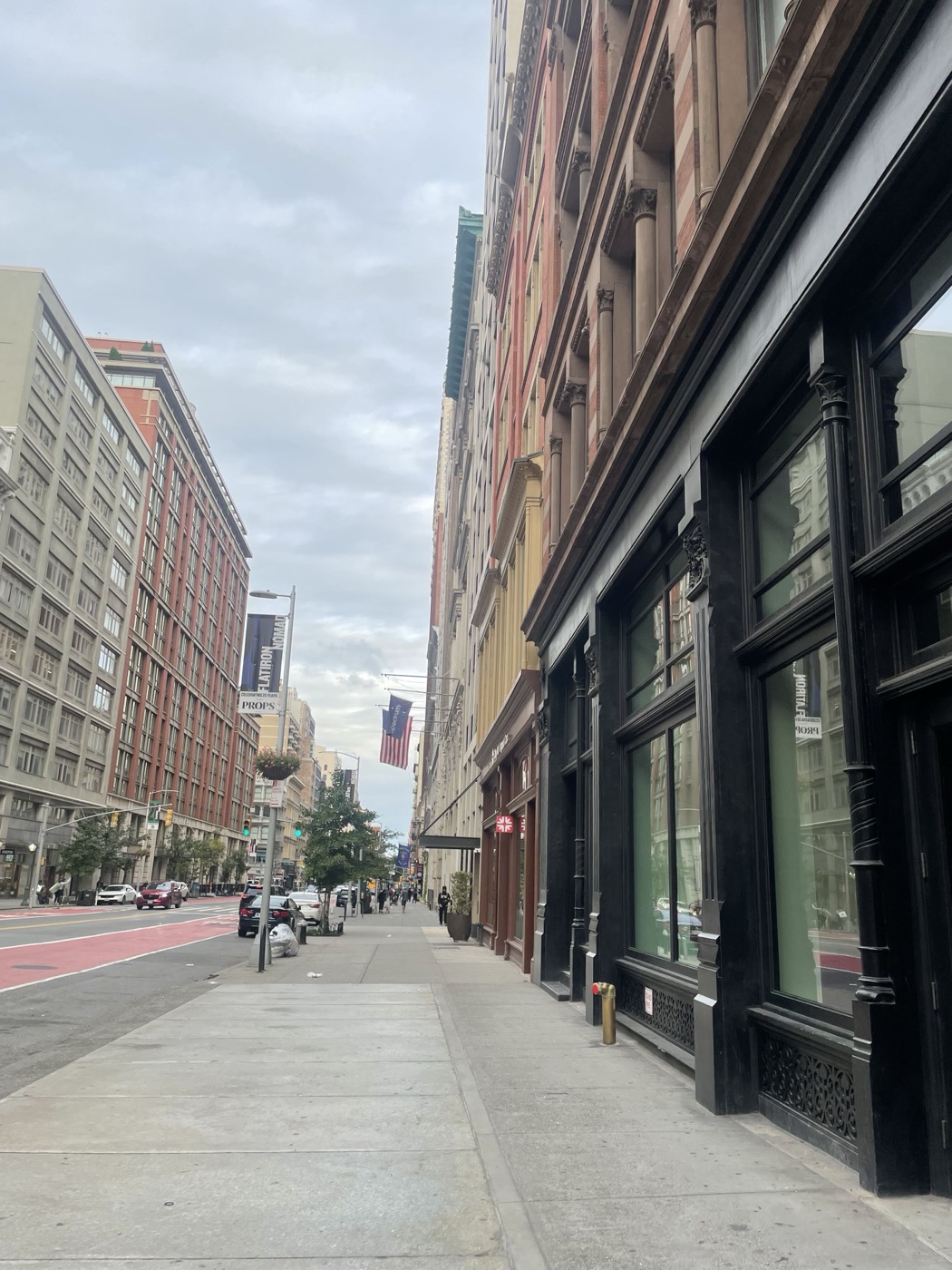 West 23rd Street with Flatiron NoMad street banners and an American flag.